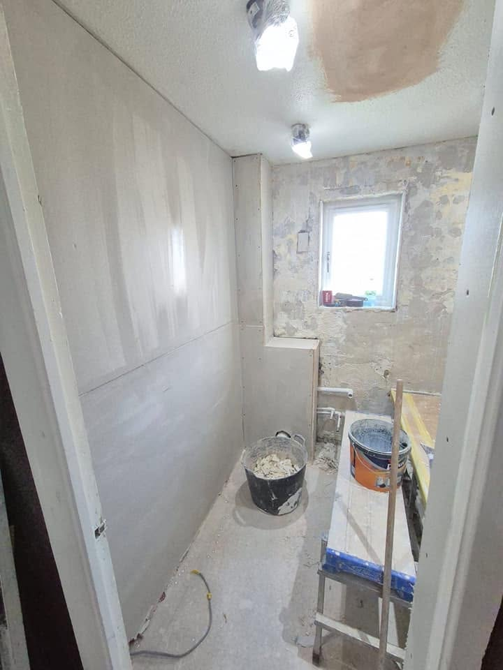 Bathroom stripped back to plasterboard and bare walls before renovation