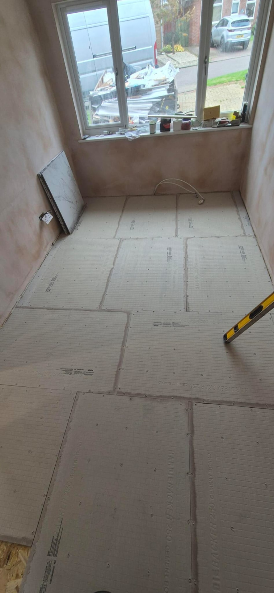 Room floor prepared with cement tile backer boards before tiling